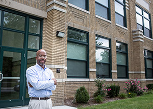 Detroit developer in front of his finished building project Kirby Center Lofts.